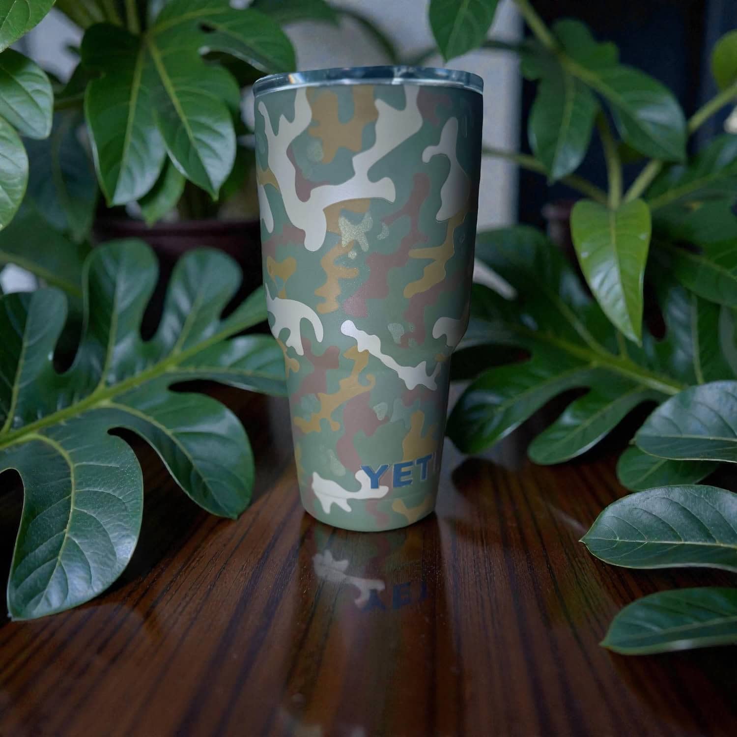 Camouflage powder-coated YET tumbler with custom finish, ideal for firearm and automotive applications.